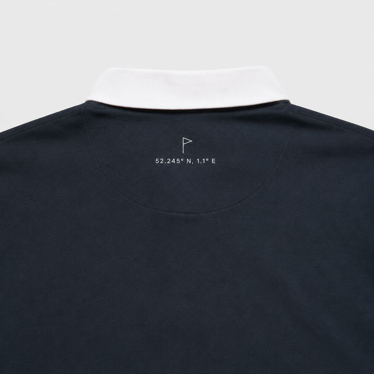 Close-up of Suffolk flag and coordinates embroidery on Navy Opening Round Golf Polo