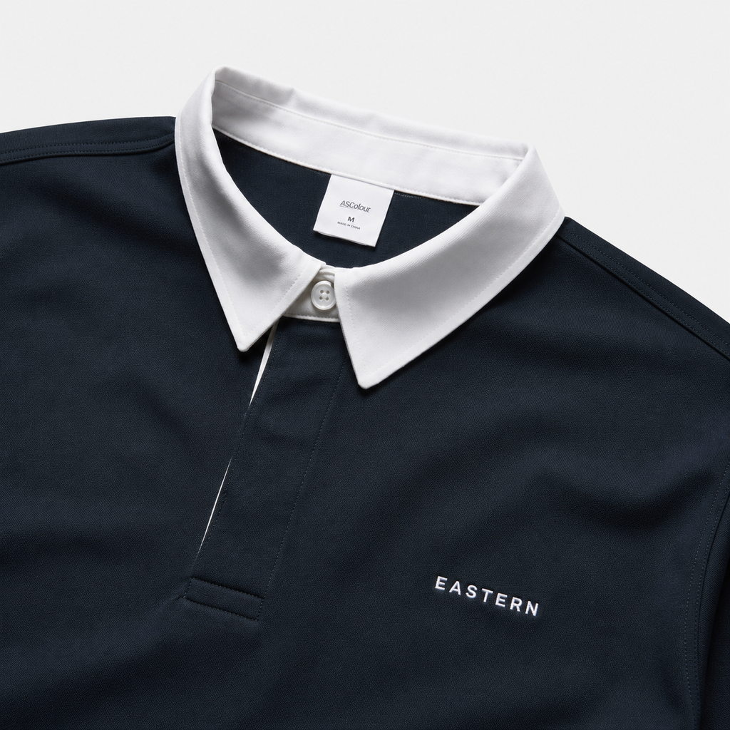 Close-up of EASTERN wordmark embroidery on Navy Opening Round Golf Polo